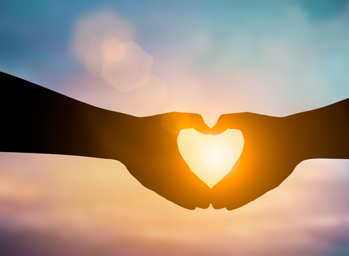 Silhouette hands making a heart shape