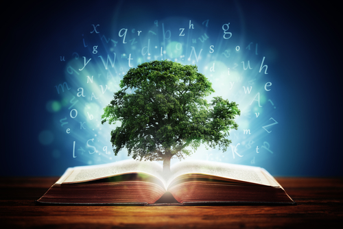 Book or tree of knowledge concept with an oak tree growing from an open book and letters flying from the pages